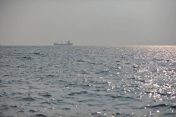 istock boat on sea surface and reflection of sun 522399166