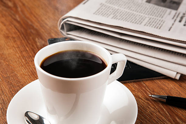 istock cup of coffee and the newspaper 522399397