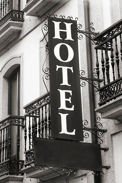 istock Cast iron hotel sign on building facade with balconies. 522400604