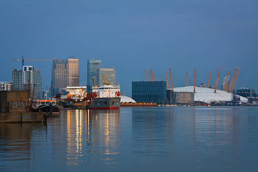 London, UK - July 4 2011: Looking towards Canary Wharf from North Greenwich over river Thames and O2 Arena.