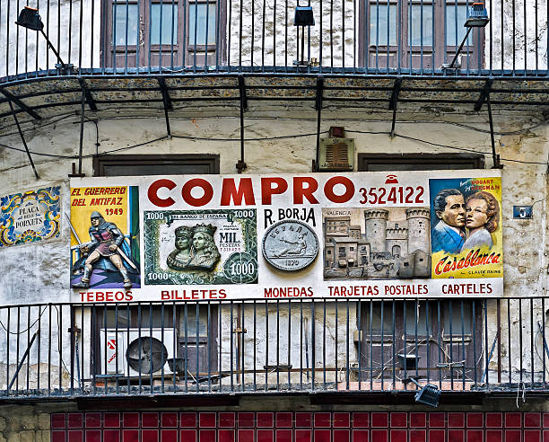 Advertisement Valencia, Spain - September 27, 2014: A placard on a derelict building advertising the sale of collectable comic books, bank notes, coins, postcards and movie posters in Valencia, Spain. humphrey bogart stock pictures, royalty-free photos & images