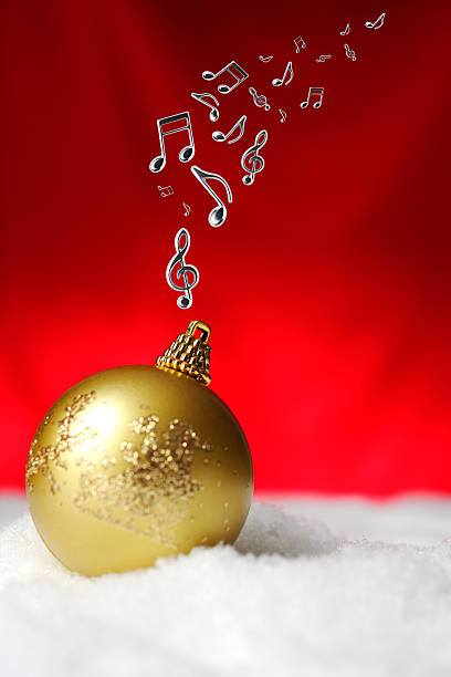 istock Golden Christmas ball on the snow with musical note 522401973