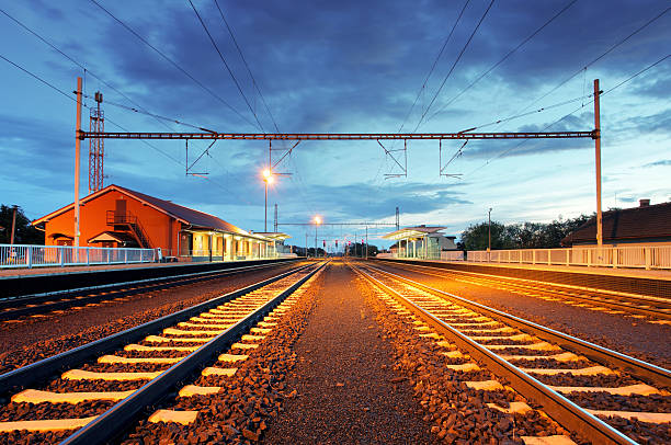 istock Train station in motion blur at night, railroad 522403121