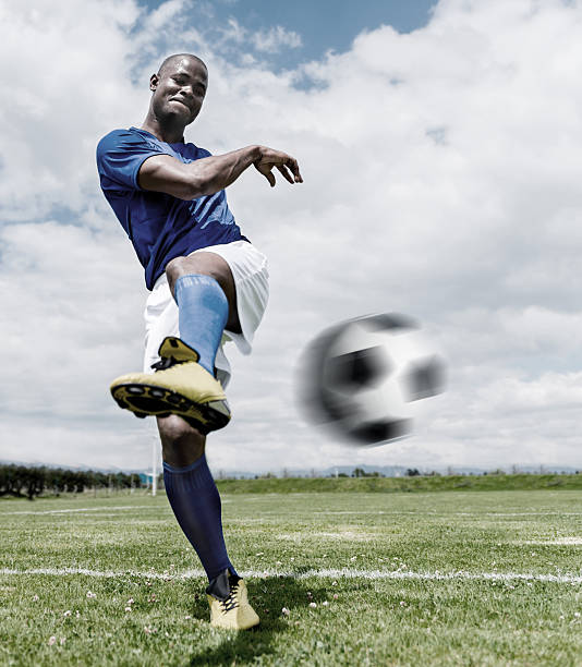 istock Football player hitting the ball 522403599