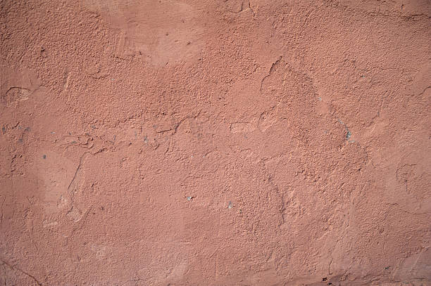 istock Texture of old wall covered with pink stucco 522403771