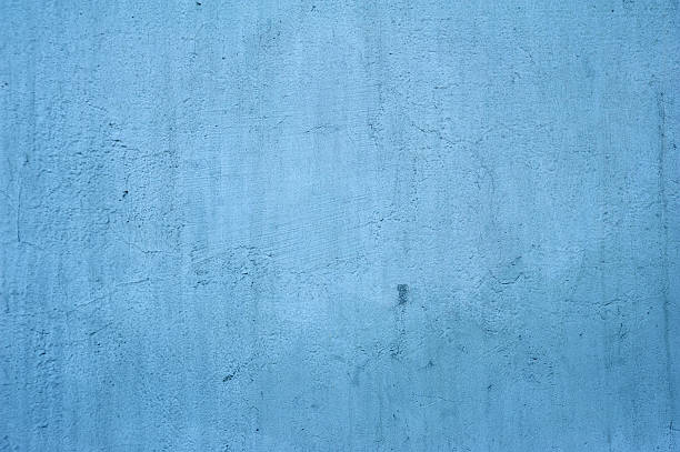 istock Texture of old wall covered with blue stucco 522404799