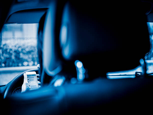asian woman checking mail box in a car.