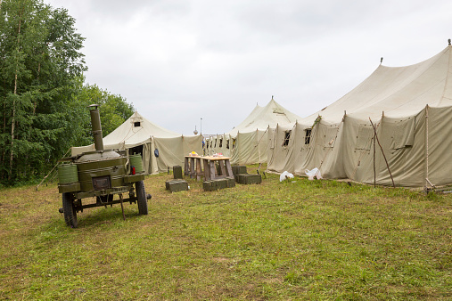white big army tent and field kitchen outdoor