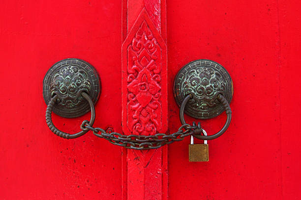 istock ancient Chinese red door with chain and key locked 522419133