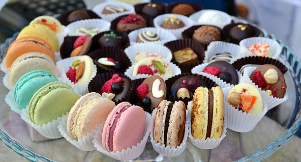 istock Colorful macarons on a plate with chocolate candies 522419397