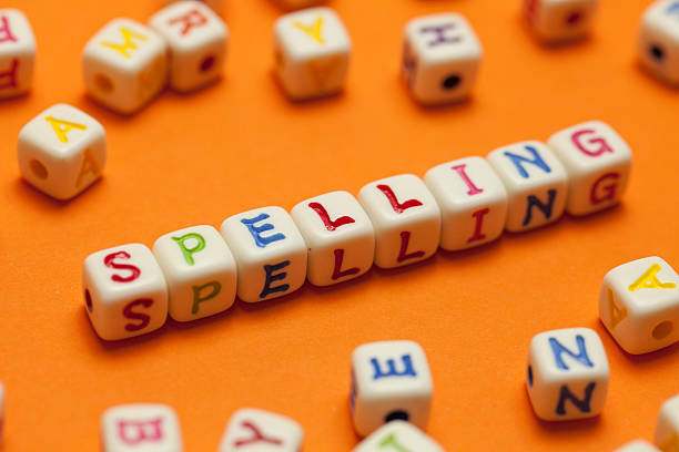 Spelling SPELLING written in letters on an orange background spelling bee stock pictures, royalty-free photos & images