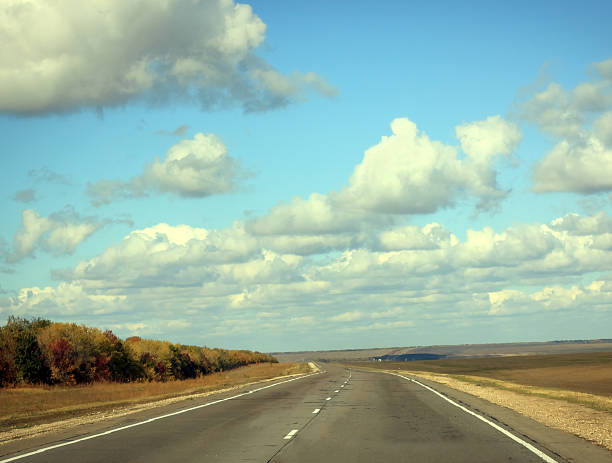 istock road in autumn day with cloud on the blue sky 522422575