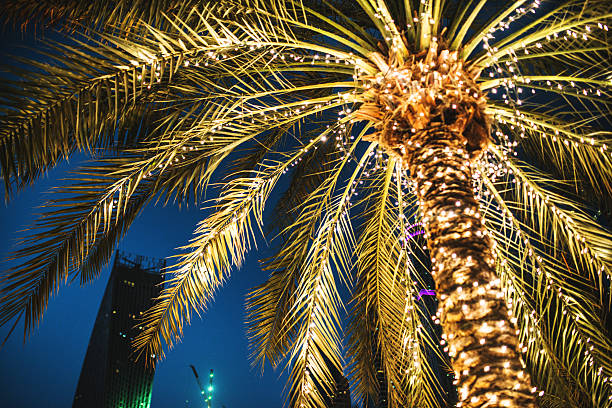Close-up of a glowing Christmas tree with garland and golden Christmas balls