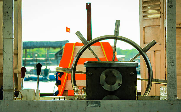 istock Sailor wheel in fishing boat 522425749