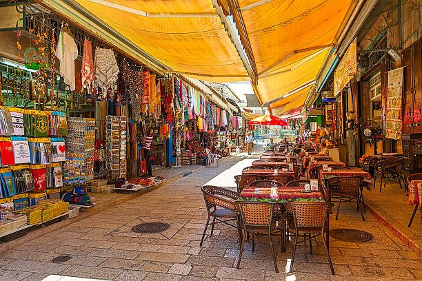 Jerusalem, Israel - July 10, 2014: Market area of Muristan - complex of streets, shops and restaurants located in the Christian quarter of the Old City of Jerusalem. This area is highly popular site with tourists and pilgrims visiting the Holy Land.