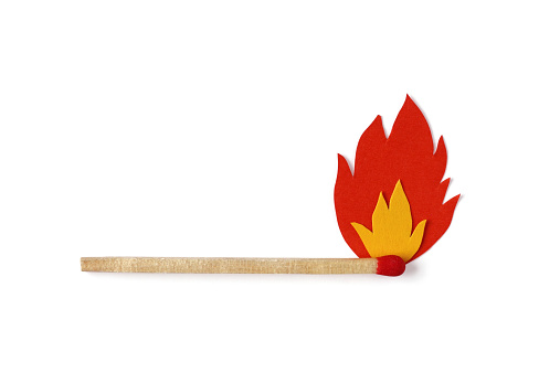 Matchstick on fire with red and yellow paper flames