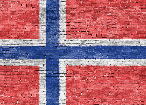 Norwegian flag over old brick wall