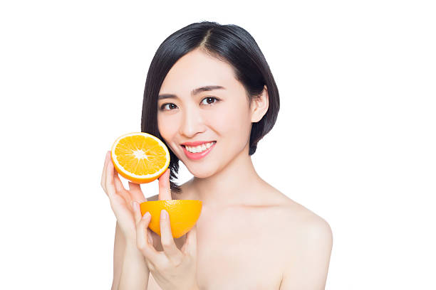 istock chinese woman with oranges in her hands 522450017
