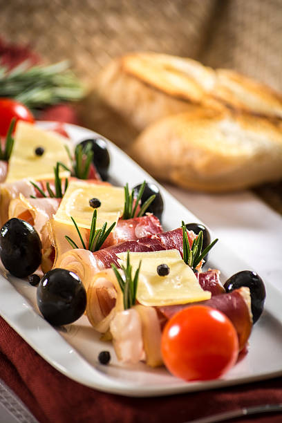 istock Parma ham, black olives, manchego cheese and bread table set 522451873