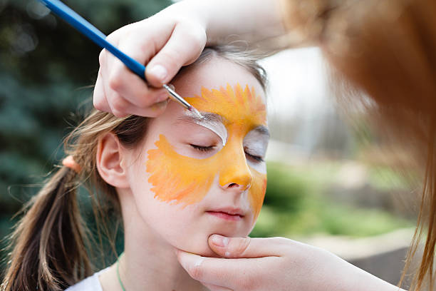 Child Drawing of orange sun which was drawn with a yellow crayon on white background.