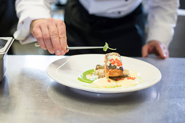 istock Chef decorating a meal made of fish 522452688