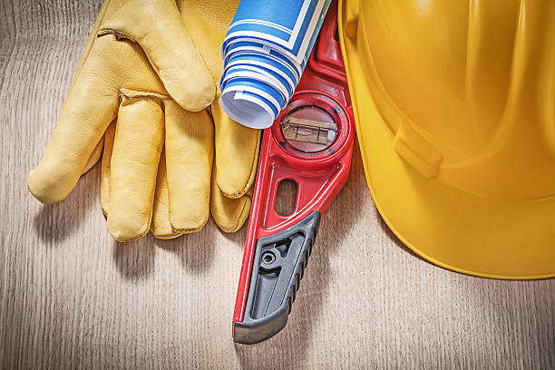 istock Building helmet safety gloves construction level blue blueprint 522453282