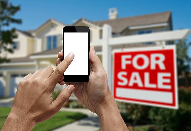 istock Hand holding smartphone with index finger touching the screen 522453771