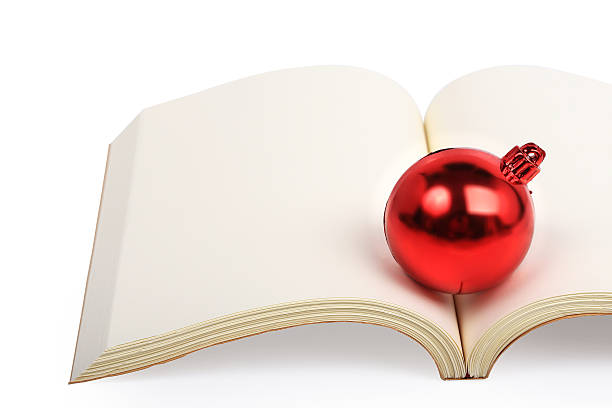 istock christmas ball on open book isolated 522454409