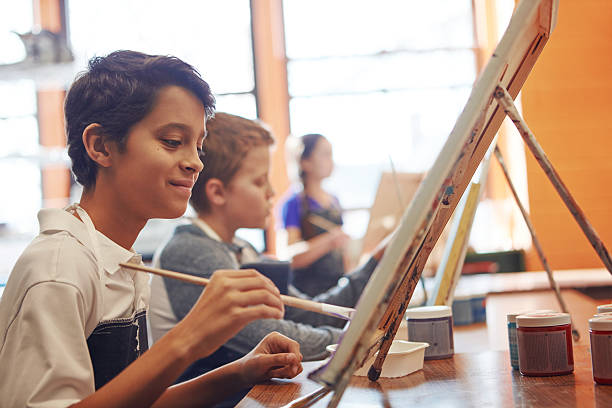 Painting by heART Shot of a young schoolboy in an art class art class photos stock pictures, royalty-free photos & images
