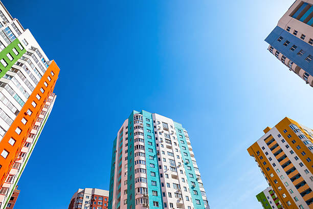 istock New tall apartment buildings against blue sky background 522461550