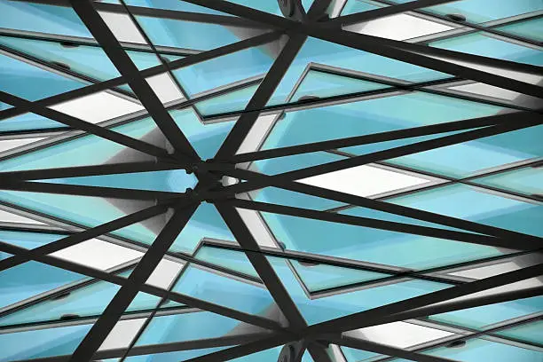 Fragment of office building roof / ceiling, a glazed aluminum structure with triangular pattern. Abstract architectural or technological background composition.