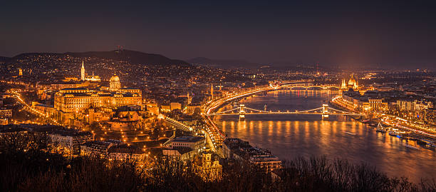 Cityscape of Budapest, Hungary at Night Panoramic View of Budapest with Street Lights and the Danube River at Twilight as Seen from Gellert Hill Lookout Point gellert stock pictures, royalty-free photos & images
