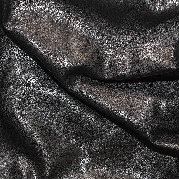 istock Black leather background in the folds 522462892