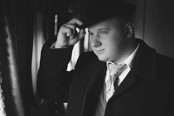 istock portrait of man in bowler hat looking out train 522466764