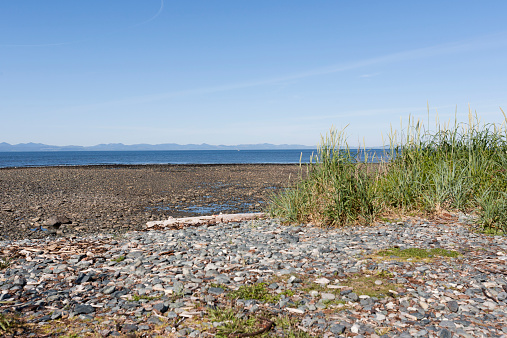 A beach on Hornby Island in British Columbia. You can see the mountains of Vancouver Island from this viewpoint.