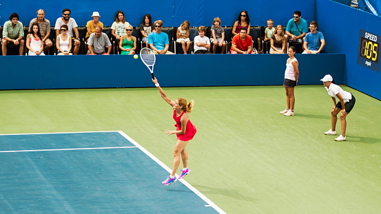 Professional Woman Athlete Receives and Lands Perfect Volley Shot and Celebrates Winning. Female Tennis Player Hitting Ball with Racquet on Championship Match. World Tournament Event Concept.