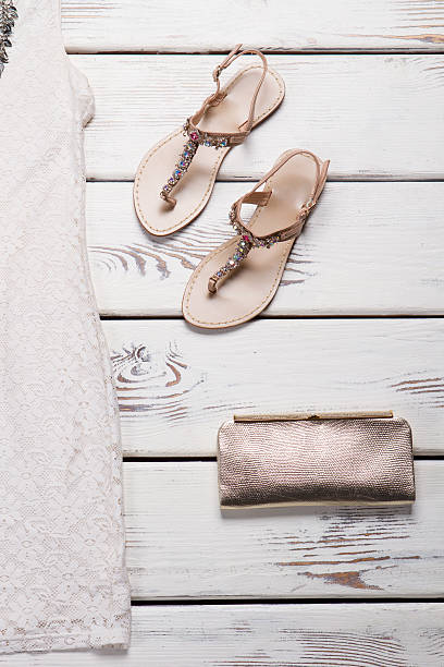 istock Beige sandals with clutch bag. 522471374