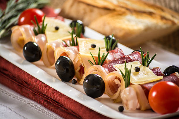 istock Parma ham, black olives, manchego cheese and bread table set 522471819