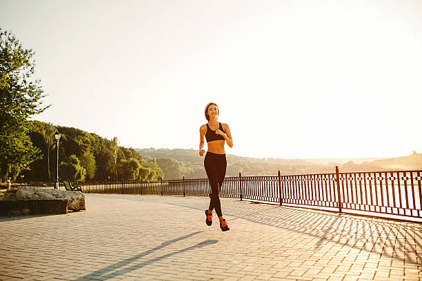 istock Running woman. Runner jogging in sunny bright light. Female fitn 522472327