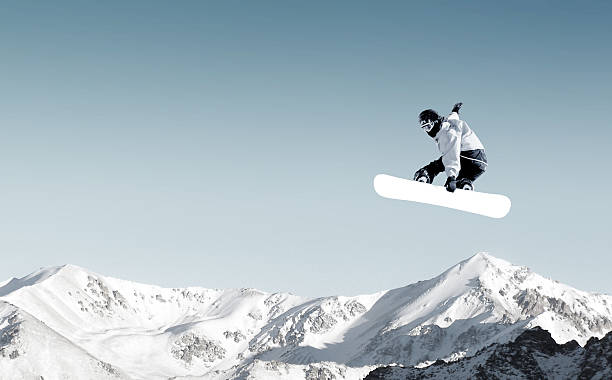 Snowboarding sport Snowboarder making high jump in clear blue sky snowboard stock pictures, royalty-free photos & images