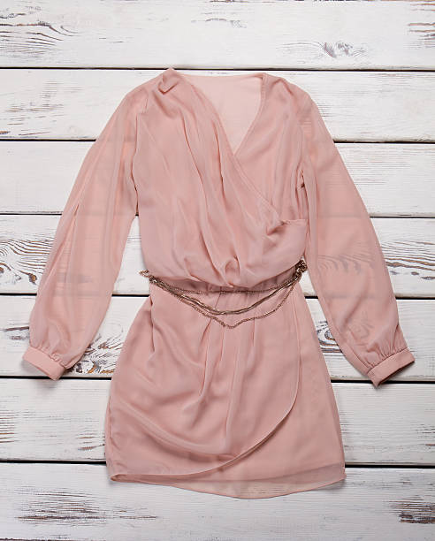 istock Peach dress with chain belt. 522472734