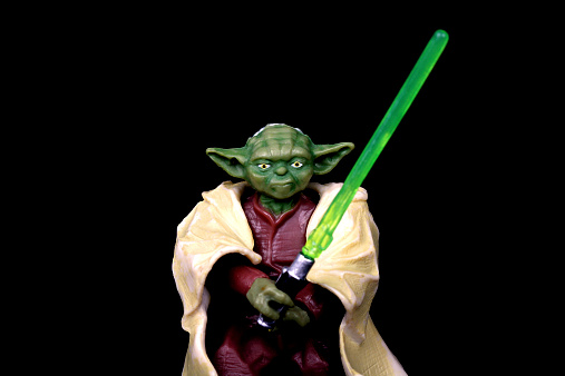 Vancouver, Canada - March 25, 2014: A model of the character Yoda, from the Star Wars Film Franchise, against a black background.