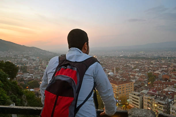 istock Backpacker traveler watching the cityscape from high hill 522473190