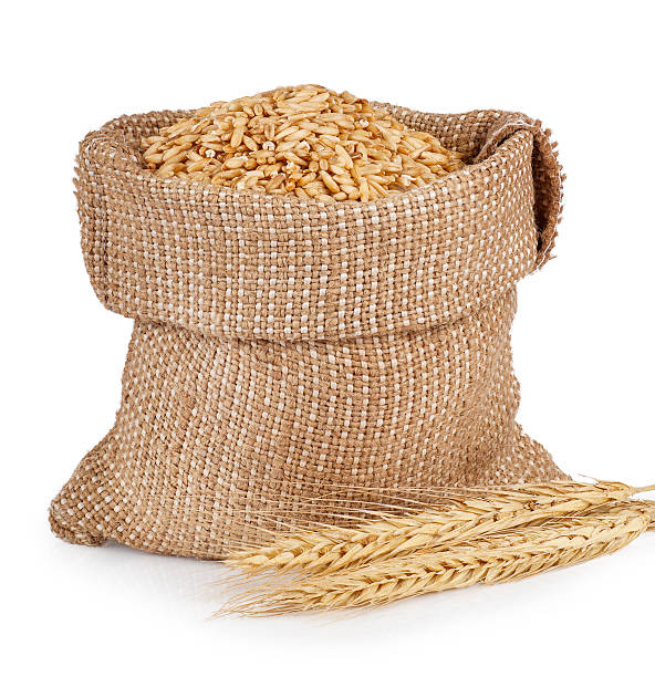 istock Cereal grains of wheat in bag isolated on white 522473266