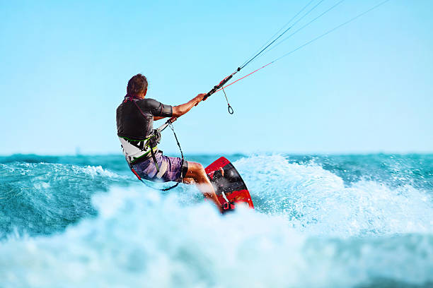 Kiteboarding, Kitesurfing. Water Sports. Kitesurf Action On Wave Kiteboarding, Kitesurfing. Water Sports. Professional Kite Surfer In Action On Waves In Ocean. Extreme Sport. Healthy Active Lifestyle. Hobby. Recreational Sporting Activity. Summer Fun, Adventure kiteboarding stock pictures, royalty-free photos & images