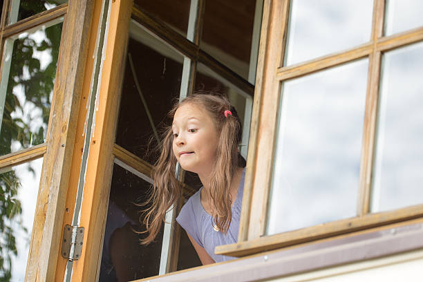 istock curious girl looks out 522474076