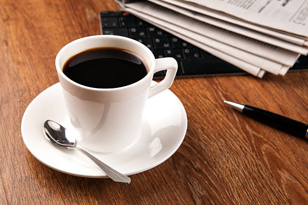 istock cup of coffee and the newspaper 522474715