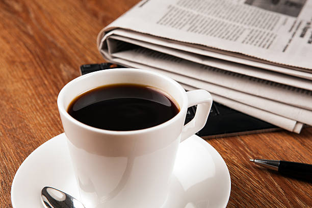 istock cup of coffee and the newspaper 522474731