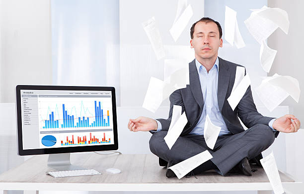istock Businessman Meditating By Computer In Office 522475031