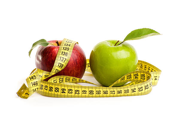 istock Apples, flowers and measuring tape. 522475776